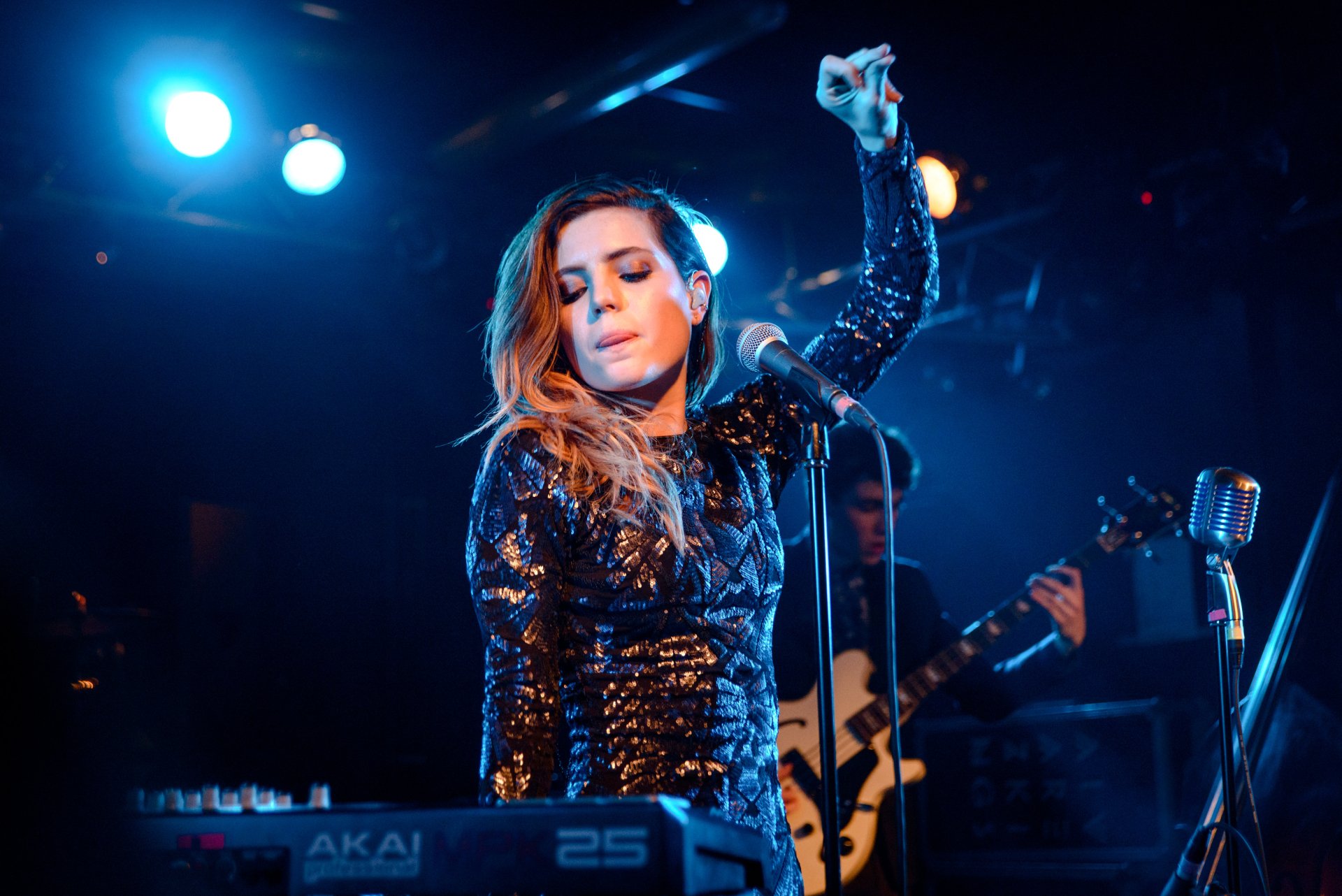 HD wallpaper of Sydney Sierota from Echosmith performing live on stage.