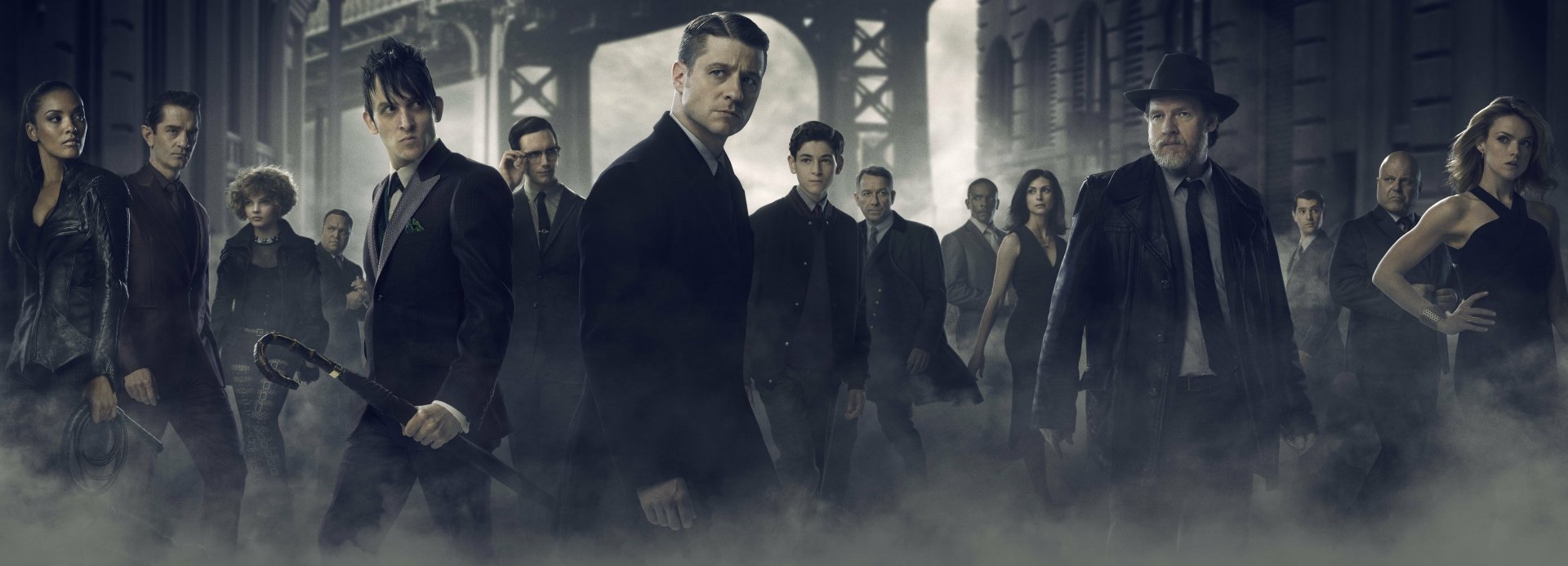 4K Ultra HD wallpaper featuring key characters Selina Kyle, James Gordon, and Bruce Wayne from the TV show Gotham, with a dark, foggy urban backdrop.