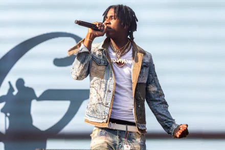 HD desktop wallpaper featuring Polo G performing with a microphone, showcasing dynamic stage presence.
