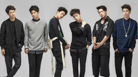 A stylish HD wallpaper featuring the K-pop group iKON poses together, showcasing their unique fashion and dynamic presence against a minimalist background.