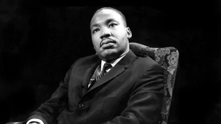 HD desktop wallpaper featuring a black and white portrait of Dr. Martin Luther King Jr. sitting thoughtfully.