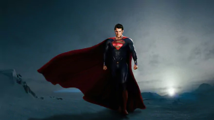 HD wallpaper featuring Henry Cavill as Superman from the movie Man of Steel, standing heroically with his red cape flowing against a dark, moody background.