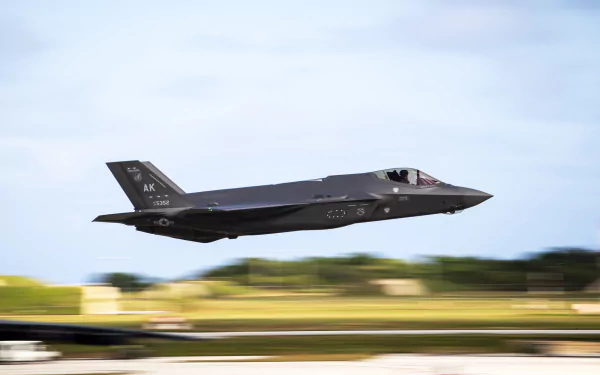 Motion blur captures a Lockheed Martin F-35 Lightning II jet fighter in flight over a blurred landscape. Military warplane shown in 4K Ultra HD detail.