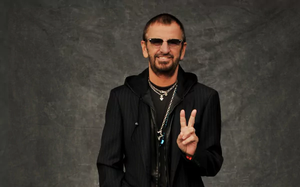 HD desktop wallpaper featuring a person posing with a peace sign, set against a textured grey background.