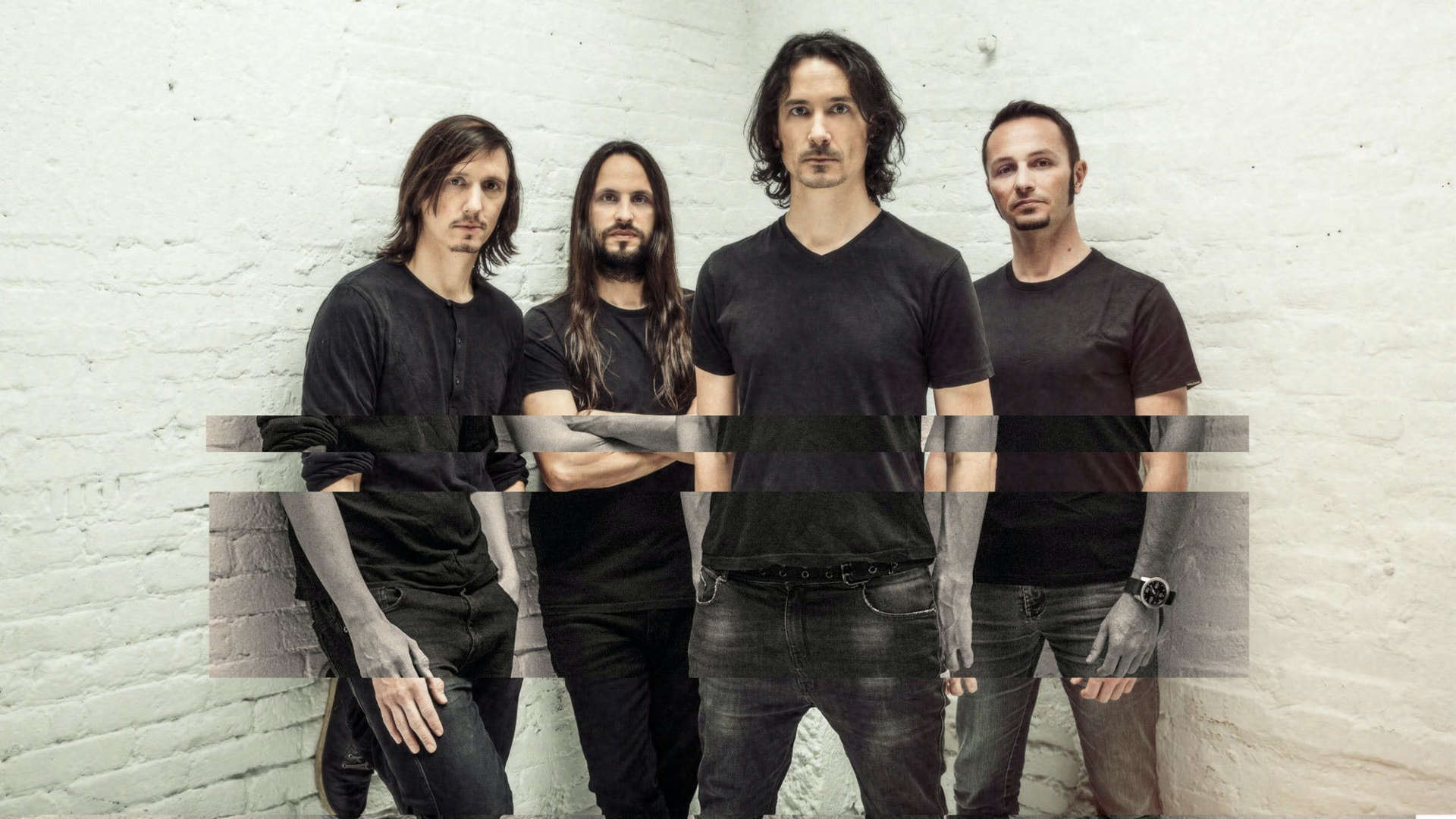 HD wallpaper featuring a band of four members standing against a white brick wall background, tagged with Gojira.