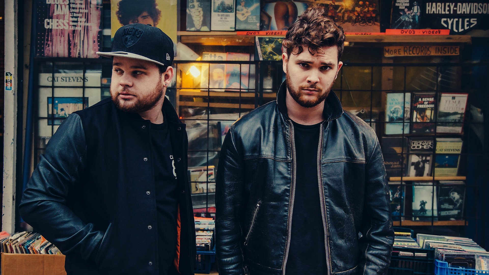 Royal Blood band members posing in front of a music store for an HD desktop wallpaper and background.