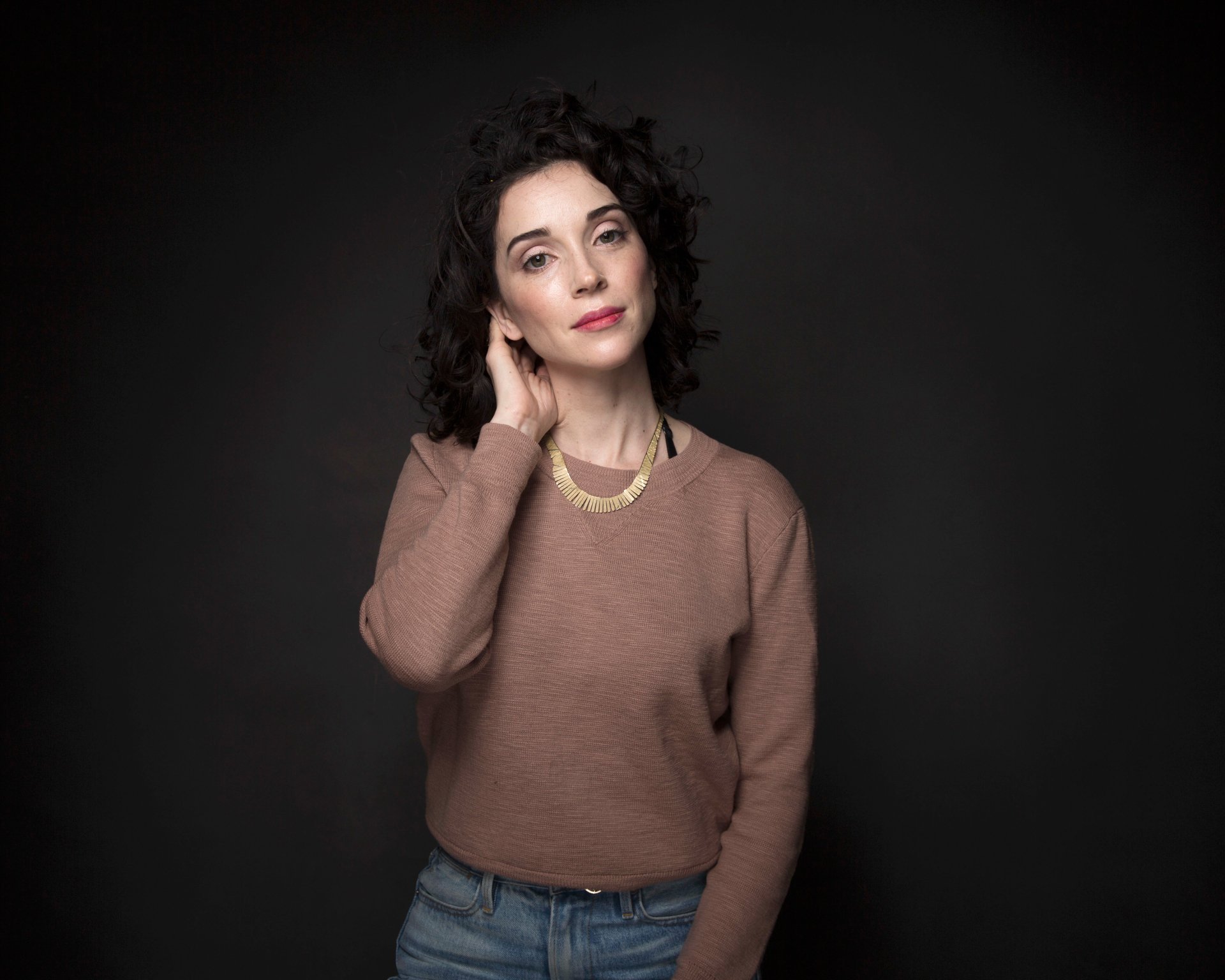 Portrait of St. Vincent, a woman in fashion-forward attire, captured in a 4K Ultra HD music-themed PC desktop wallpaper and background.