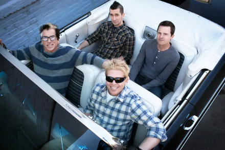 HD desktop wallpaper featuring The Offspring band members smiling in a convertible car, suitable as a vibrant background.