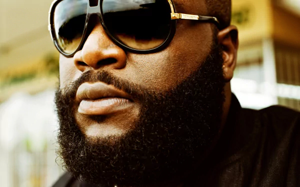 HD desktop wallpaper featuring a close-up of Rick Ross wearing sunglasses.