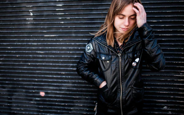 HD desktop wallpaper featuring a reflective individual posing against a corrugated backdrop, tagged as Julien Baker.