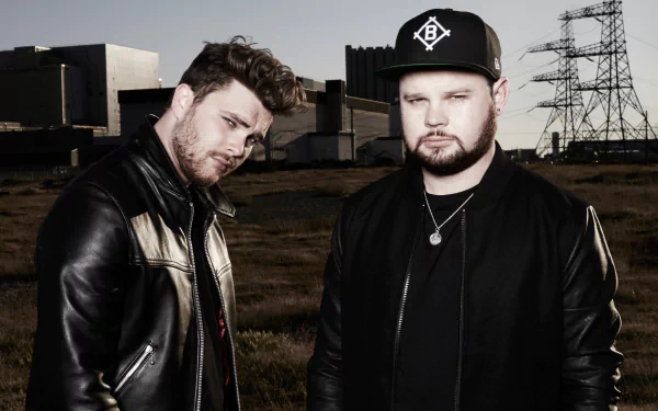 Royal Blood band members posing for an HD desktop wallpaper with an industrial backdrop.