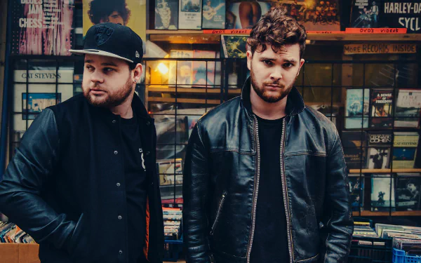 Royal Blood band members posing in front of a music store for an HD desktop wallpaper and background.