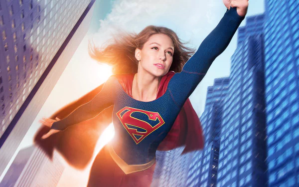 HD desktop wallpaper featuring Melissa Benoist as Kara Danvers from the TV show Supergirl, soaring through a city skyline.
