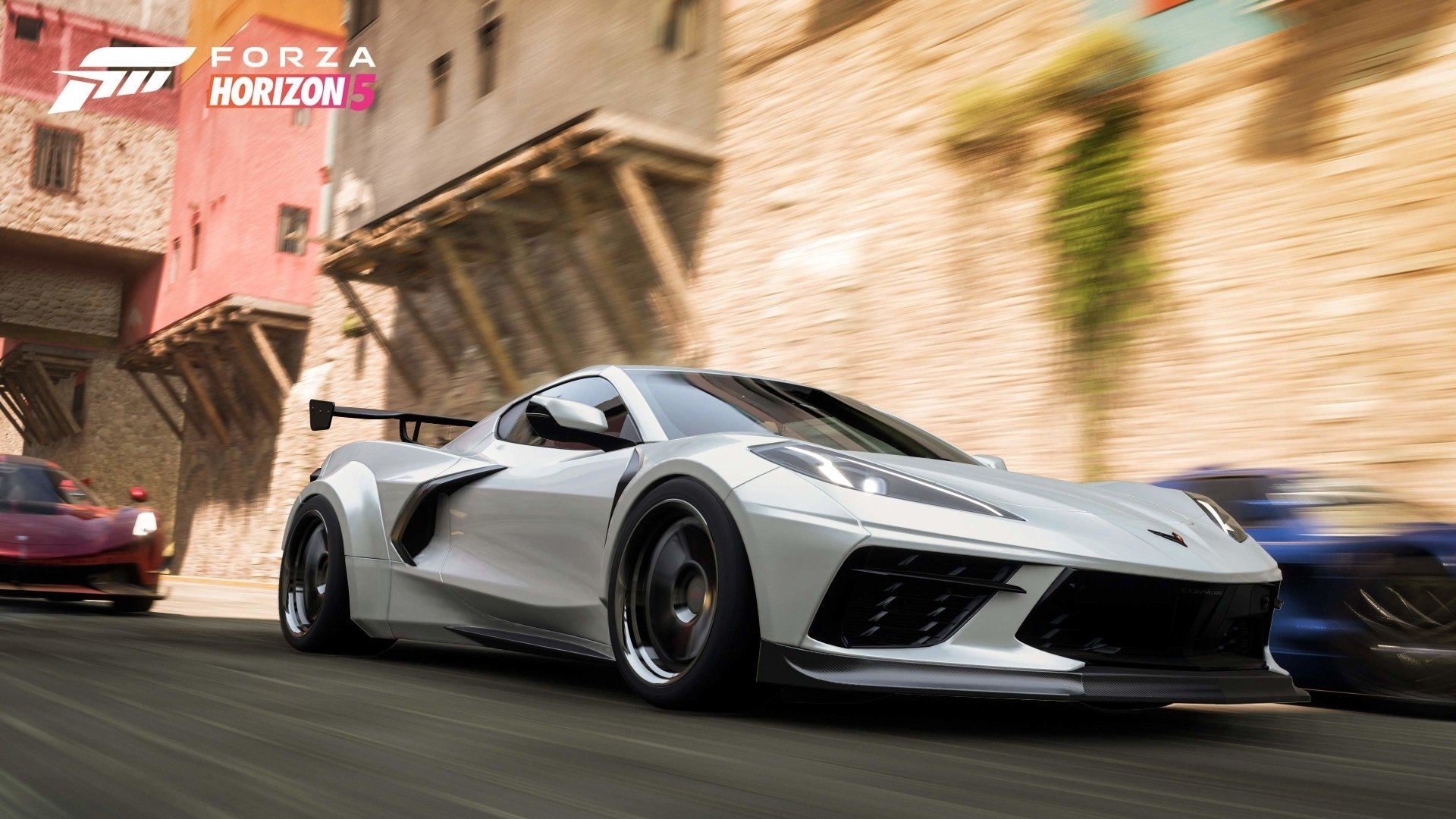 High-definition Forza Horizon 5 PC wallpaper featuring a sleek silver sports car racing through a sunlit, rustic village street.