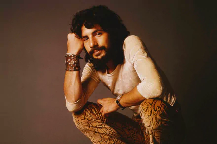 HD desktop wallpaper featuring a portrait of a bearded man in a relaxed pose with a vintage aesthetic.