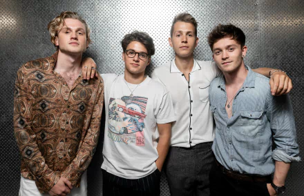 HD desktop wallpaper featuring a close-up group photo of four members of the band The Vamps posing together against a textured background, suited for music fans' desktop and background themes.