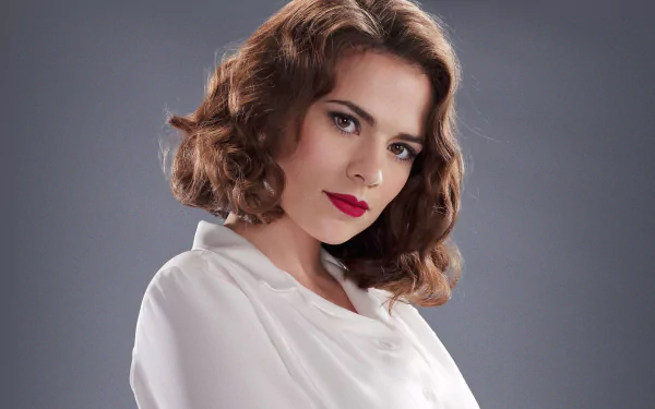 HD desktop wallpaper featuring Hayley Atwell as Peggy Carter from the TV show Agent Carter, showcasing her classic look with vintage curls and red lipstick against a neutral background.