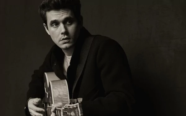 HD wallpaper featuring a monochrome portrait of a man holding a guitar, providing an artistic backdrop for desktops.