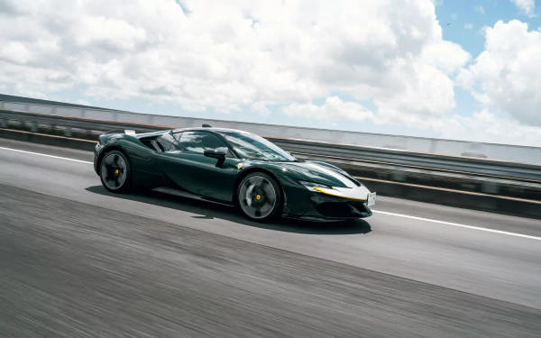 4K Ultra HD PC desktop wallpaper and background of a green Ferrari SF90 Stradale supercar vehicle speeding along a coastal highway under a bright, cloud-filled sky.