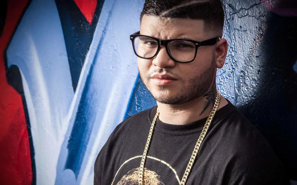 HD desktop wallpaper featuring Farruko posing confidently against a vibrant graffiti background, showcasing a blend of urban art and modern music culture.