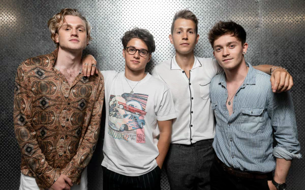 HD desktop wallpaper featuring a close-up group photo of four members of the band The Vamps posing together against a textured background, suited for music fans' desktop and background themes.
