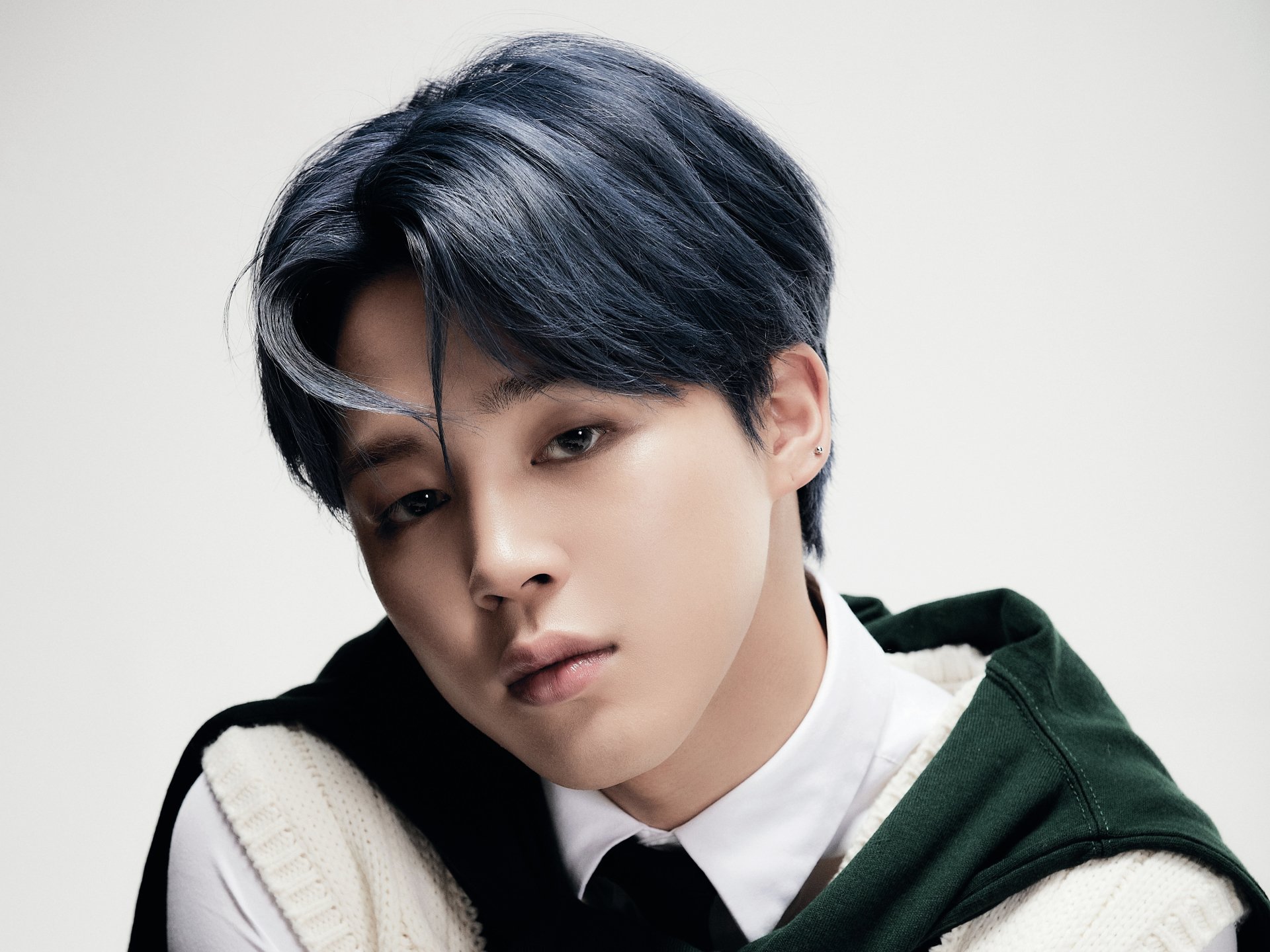 Close-up portrait of Jimin from BTS, a K-pop singer, captured in a high-resolution 4K Ultra HD image, highlighting his soft expression and stylish dark hair.