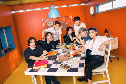 BTS members RM, Suga, Jin, J-Hope, Jimin, V, and Jungkook gather around a table in a vibrant room, captured in a 4K Ultra HD K-pop desktop wallpaper.