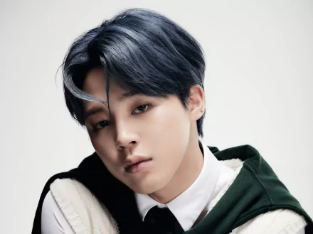 Close-up portrait of Jimin from BTS, a K-pop singer, captured in a high-resolution 4K Ultra HD image, highlighting his soft expression and stylish dark hair.
