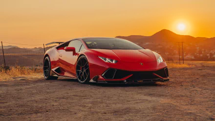 A red Lamborghini Huracan supercar parked on a dirt road with mountains and a sunset in the background, captured in stunning 4K Ultra HD for a PC desktop wallpaper.