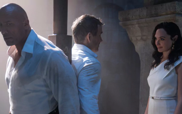 HD desktop wallpaper featuring Gal Gadot, Ryan Reynolds, and Dwayne Johnson from the movie Red Notice, set against a dramatic, shadowed background.