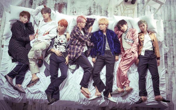 HD PC desktop wallpaper featuring BTS members RM, Suga, Jin, J-Hope, Jimin, V, and Jungkook in a relaxed, stylish group pose with a soft, artistic background.