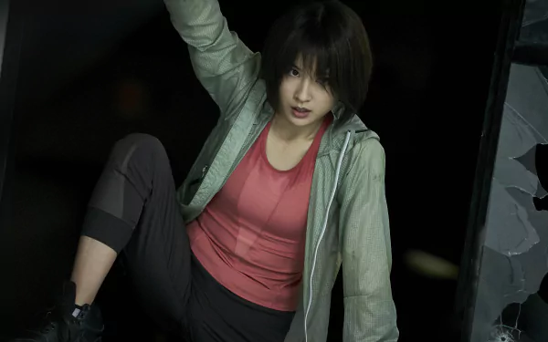 4K Ultra HD PC desktop wallpaper of a scene from TV show Alice in Borderland: a tense young woman in a green jacket and red top climbs out of a dark shaft.