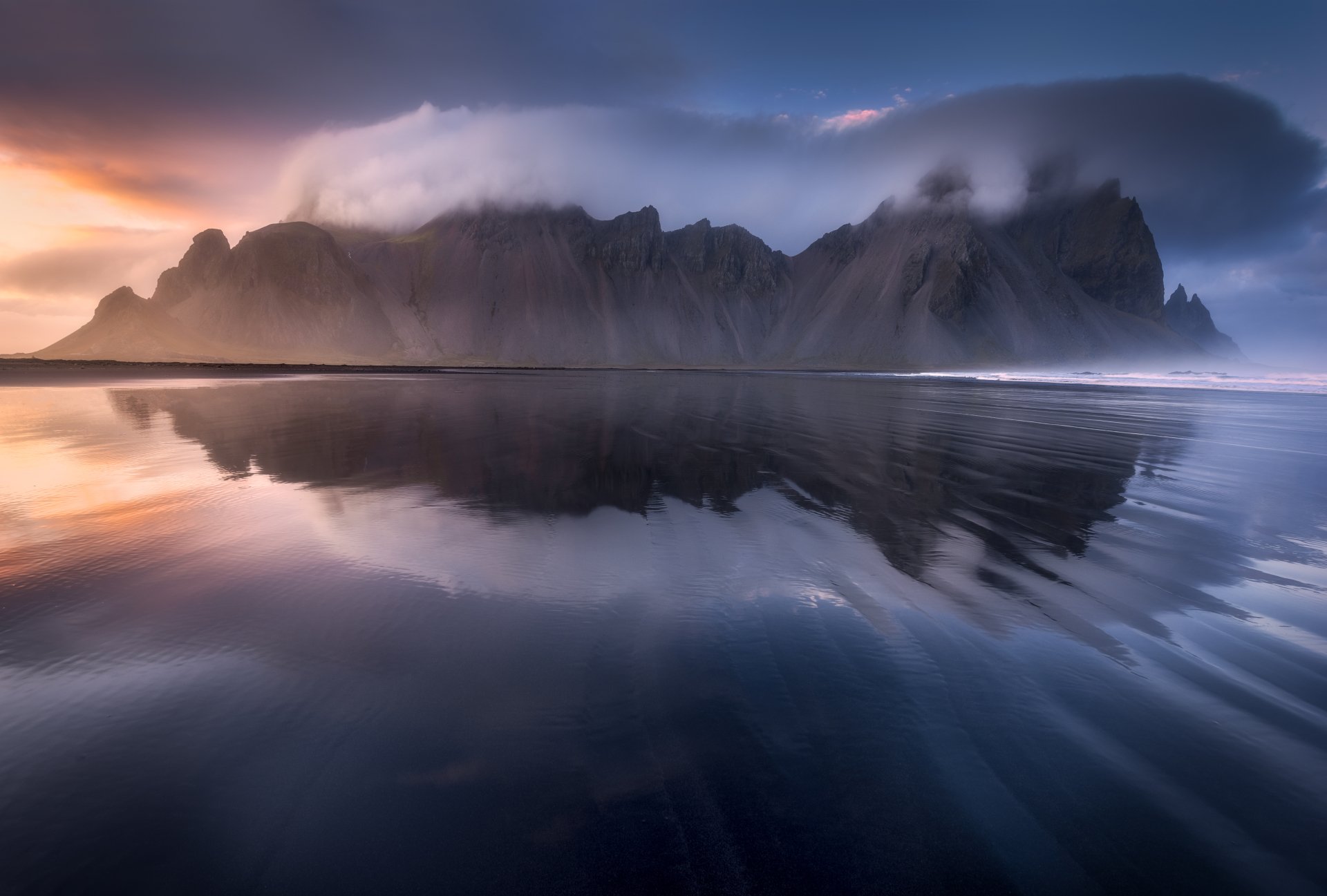 Vestrahorn mountains silhouetted at sunset, reflected on black sand and a glassy sea — 5K Ultra HD nature PC desktop wallpaper/background.