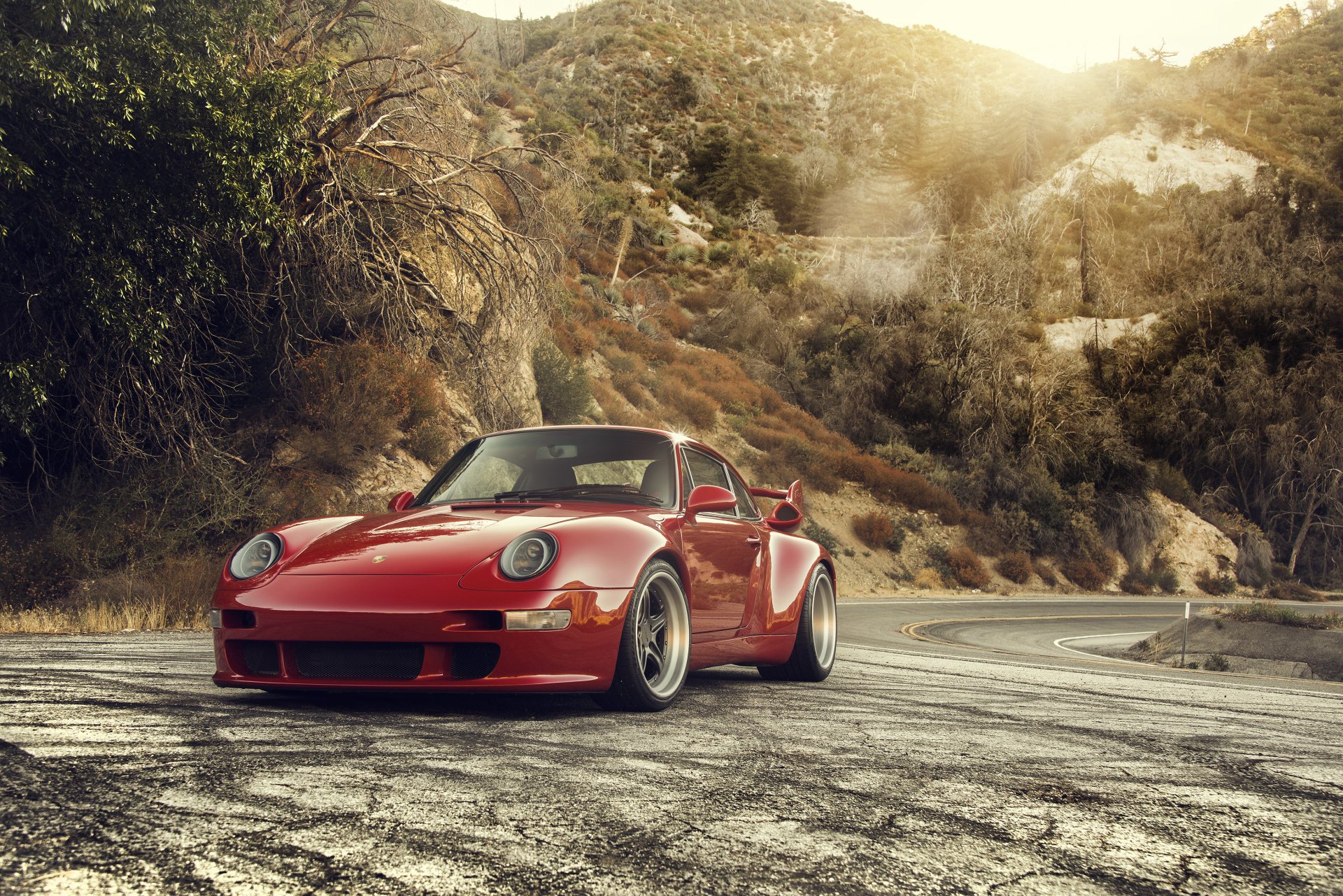 A red Gunther Werks 400R Concept, based on a Porsche 993, is parked on a scenic mountain road. The image is a high-definition desktop wallpaper and background.