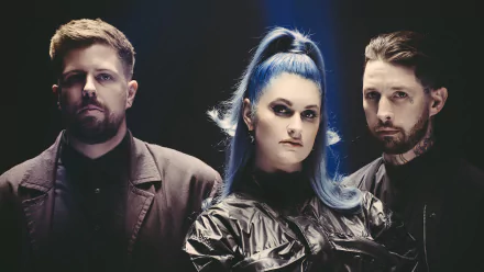 HD desktop wallpaper featuring the band Spiritbox, with two male members and a female member with striking blue hair.