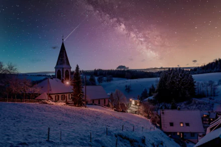 A winter night in a village with a church under a starry sky and the Milky Way, captured in a stunning HD desktop wallpaper and background photo.
