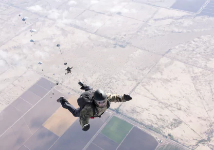  U.S. Sailors assigned to EODGRU 1 &amp; 2 deploy parachutes during military free-fall training by Charles Oki