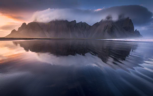 Vestrahorn mountains silhouetted at sunset, reflected on black sand and a glassy sea — 5K Ultra HD nature PC desktop wallpaper/background.