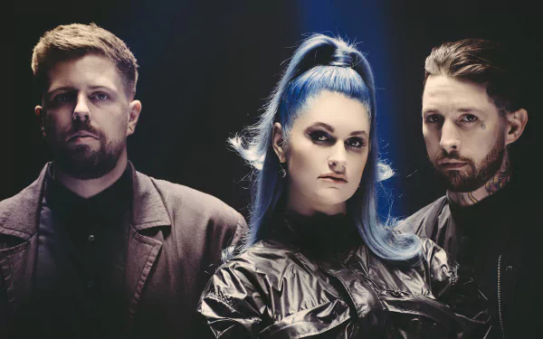 HD desktop wallpaper featuring the band Spiritbox, with two male members and a female member with striking blue hair.