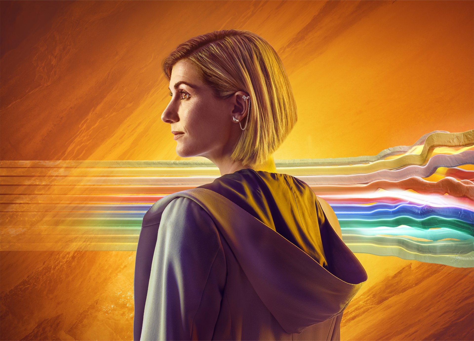 4K Ultra HD wallpaper of Jodie Whittaker as the Thirteenth Doctor from the TV show Doctor Who (2005), featuring vibrant streaks of color against a warm orange background.