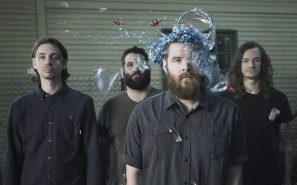HD desktop wallpaper featuring the members of Manchester Orchestra with a dynamic splash of water frozen in motion around one of their heads, providing a creative and engaging background for fans.