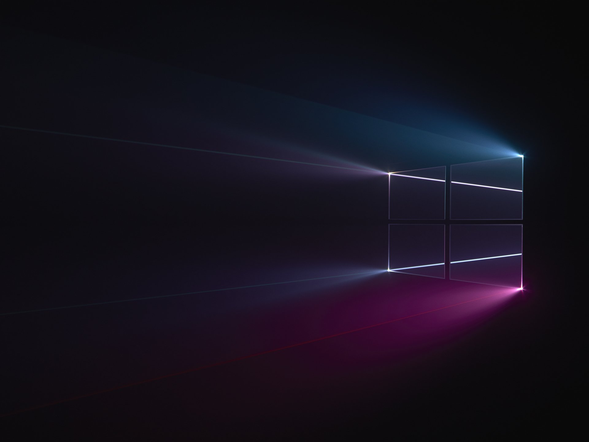 HD desktop wallpaper featuring the illuminated Windows 10 logo against a dark background, showcasing Microsoft technology with sleek light beams.