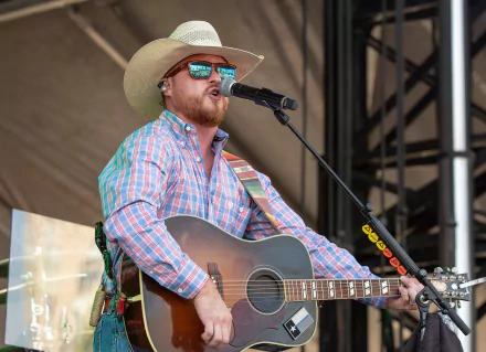 HD desktop wallpaper featuring Cody Johnson performing with a guitar.