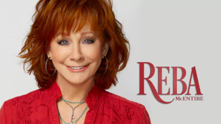 A vibrant HD wallpaper featuring Reba McEntire, showcasing her signature style with a warm smile and striking red outfit, accompanied by her name in bold lettering.