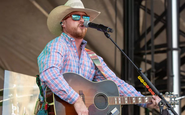 HD desktop wallpaper featuring Cody Johnson performing with a guitar.