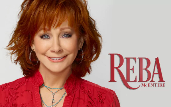 A vibrant HD wallpaper featuring Reba McEntire, showcasing her signature style with a warm smile and striking red outfit, accompanied by her name in bold lettering.