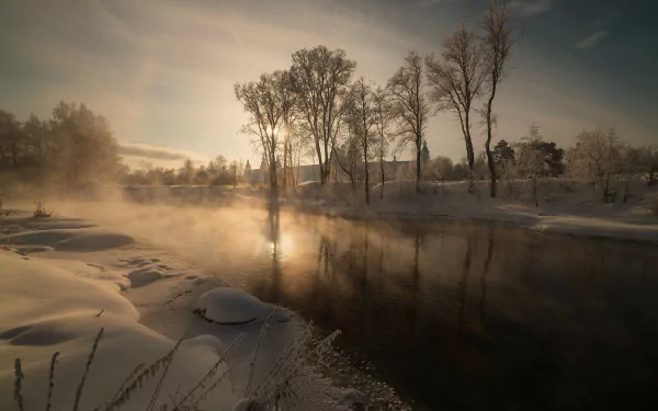4K Ultra HD PC desktop wallpaper background: misty winter nature scene with a calm river at sunrise, snow‑covered banks and bare trees reflected in glassy water.