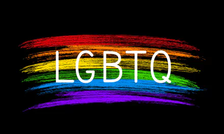 Artistic HD PC desktop wallpaper featuring the white text LGBTQ over a vibrant rainbow brushstroke on a black background.