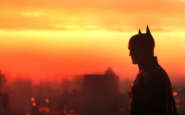 Silhouette of Batman from The Batman movie against a blazing sunset skyline, 4K Ultra HD PC desktop wallpaper and background.