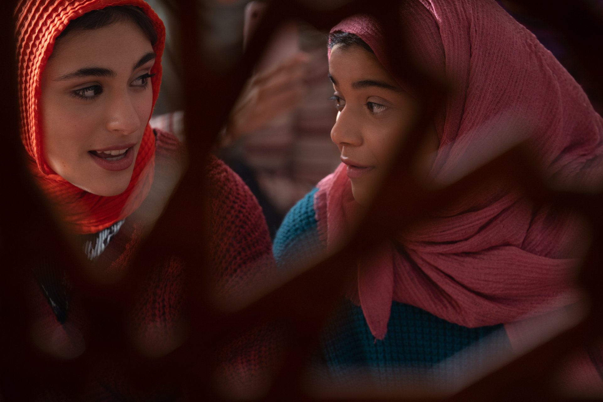 HD desktop wallpaper of Kamala Khan from the TV show Ms. Marvel — two girls in headscarves sharing a warm, attentive moment.